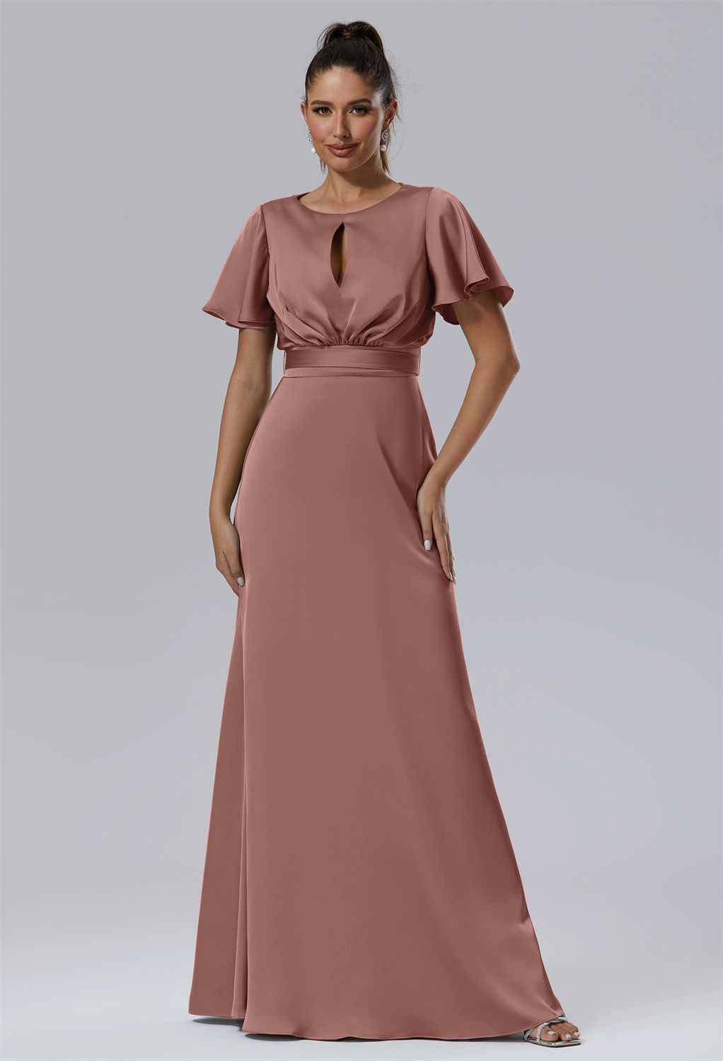 adding a playful yet sensual touch to the otherwise understated elegance of the gown. The gown's adjustable waist belt is designed to perfectly contour to one's curves
