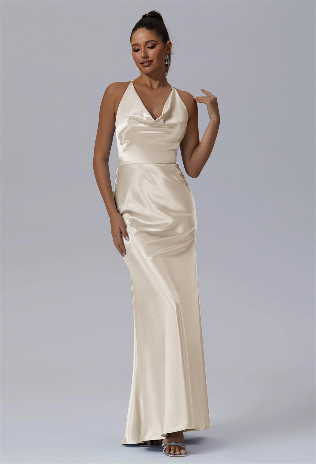 this full-length gown presents a breathtaking A-line shape. Its unique asymmetrical neckline contributes a touch of individuality