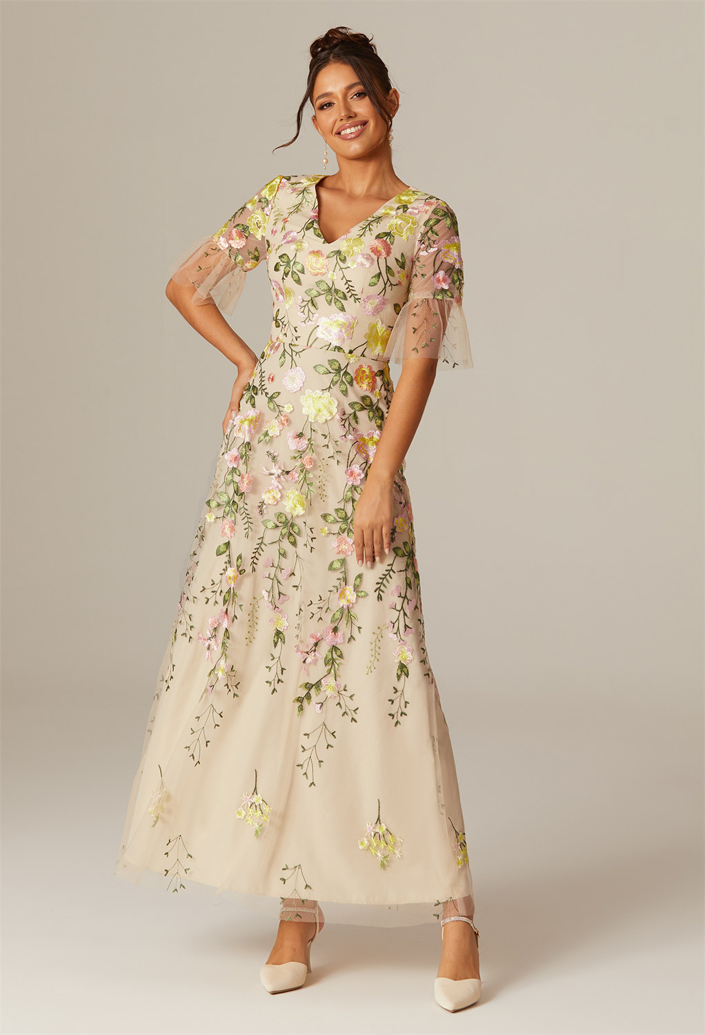 draping you in an A-line tulle canvas that cascades to the ankles