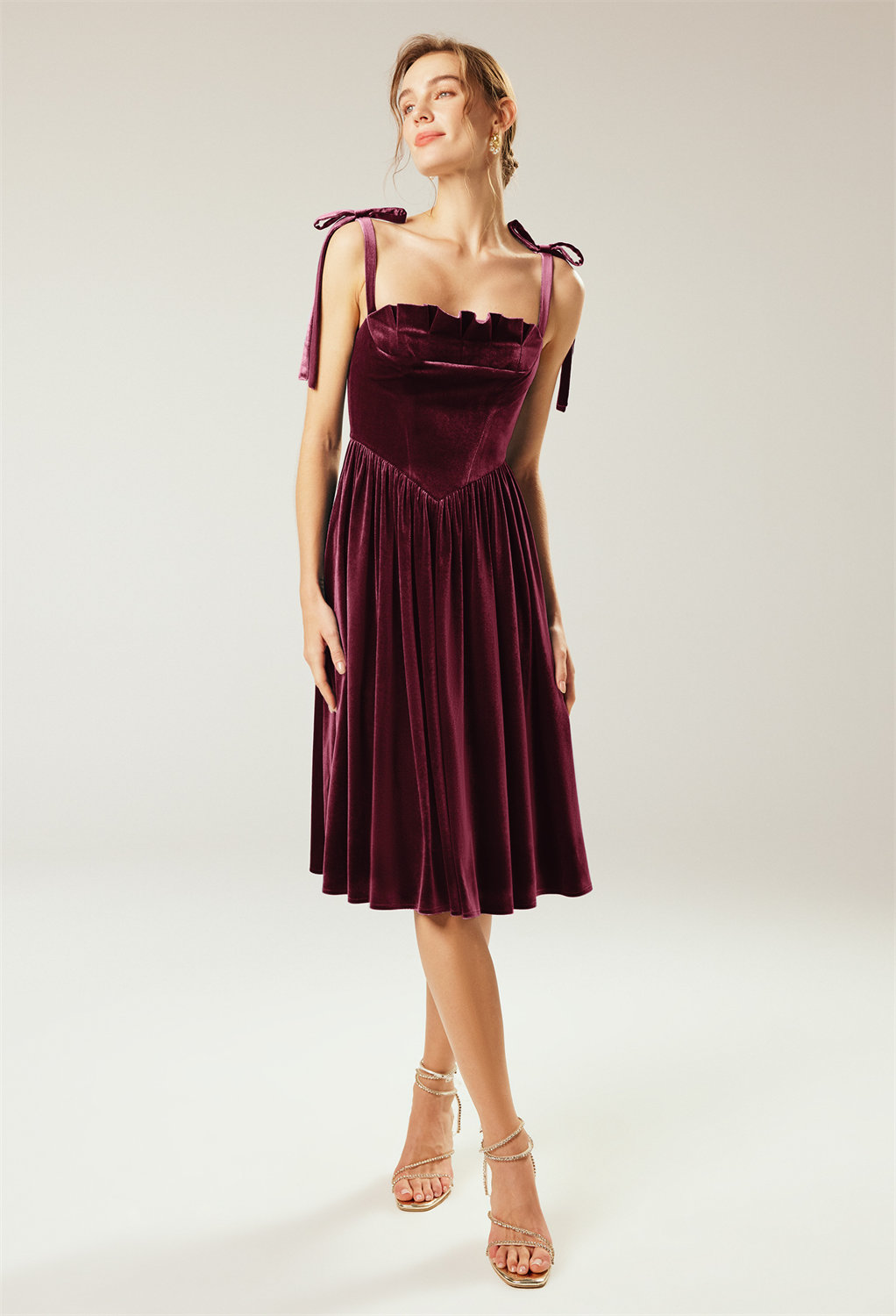 The AW Woad Dress is a dazzling velvet creation with a strapless sleeve for a sophisticated bridesmaid seeking a knee-length gown with an A-line silhouette form and a straight neckline. It comprises a flirtatious built-in bra to make your outfit comfy and