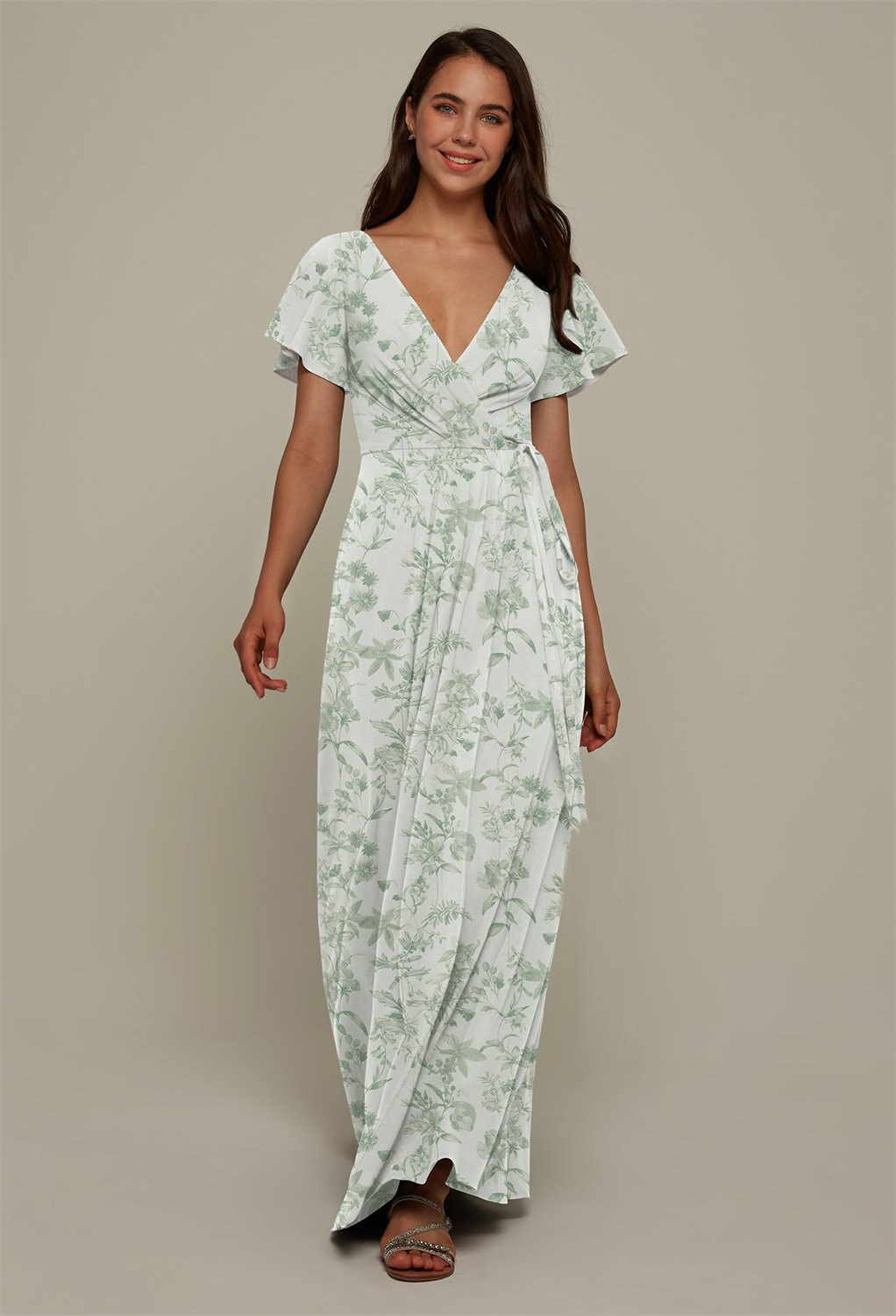 The flirty floor length Ellison dress is made from the perfect form hugging crepe fabric. The pleated A-line design of the dress offers grace and movement with each step or dance move. The plunging V-neck and short sleeves are flattering and charming and