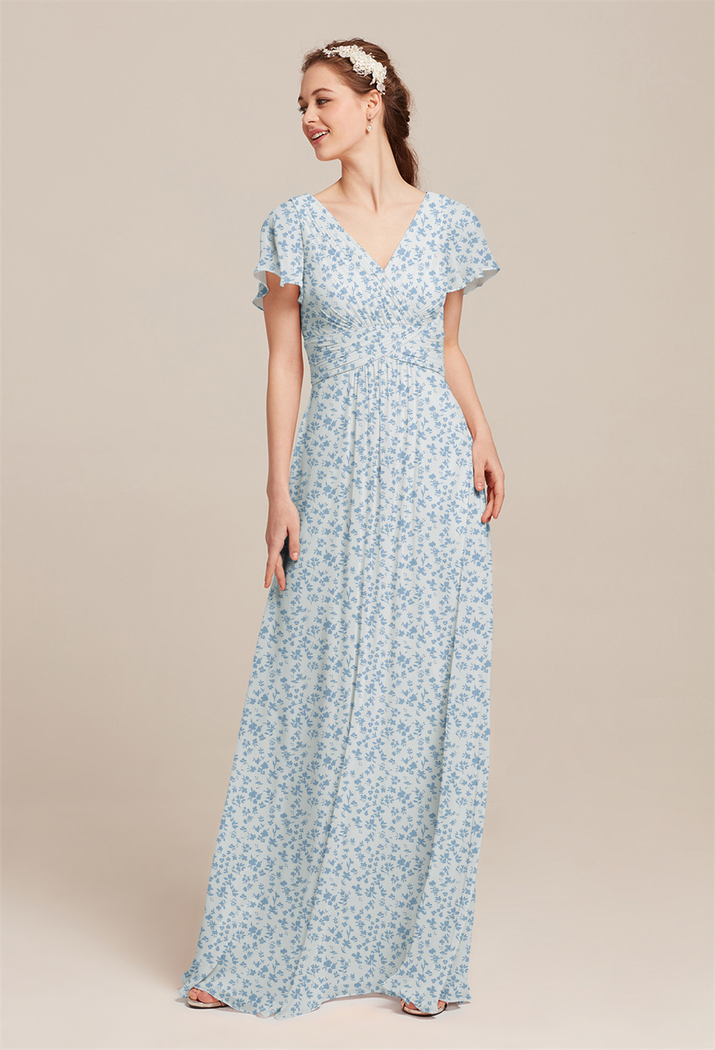 with a delicately pleated bodice that adds an elegant touch. The dress is offere