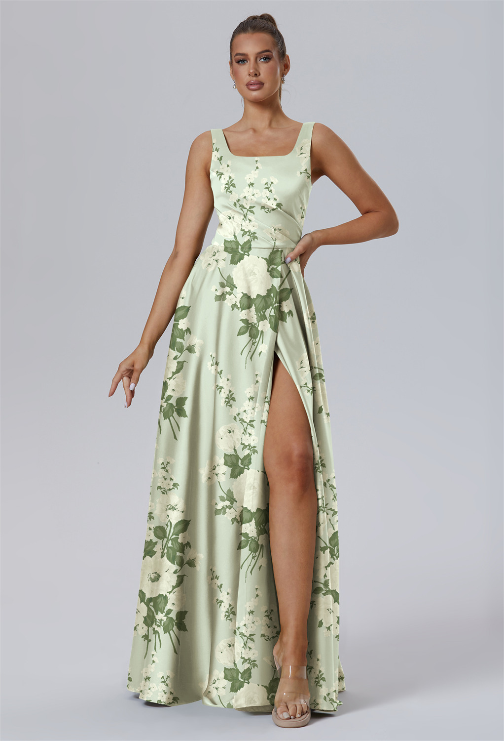 crafted in shimmering Satin Charmeuse. This floor-length A-line gown features a refined square neckline and a side slit. Having a bodice highlighted with a ruffle waistband