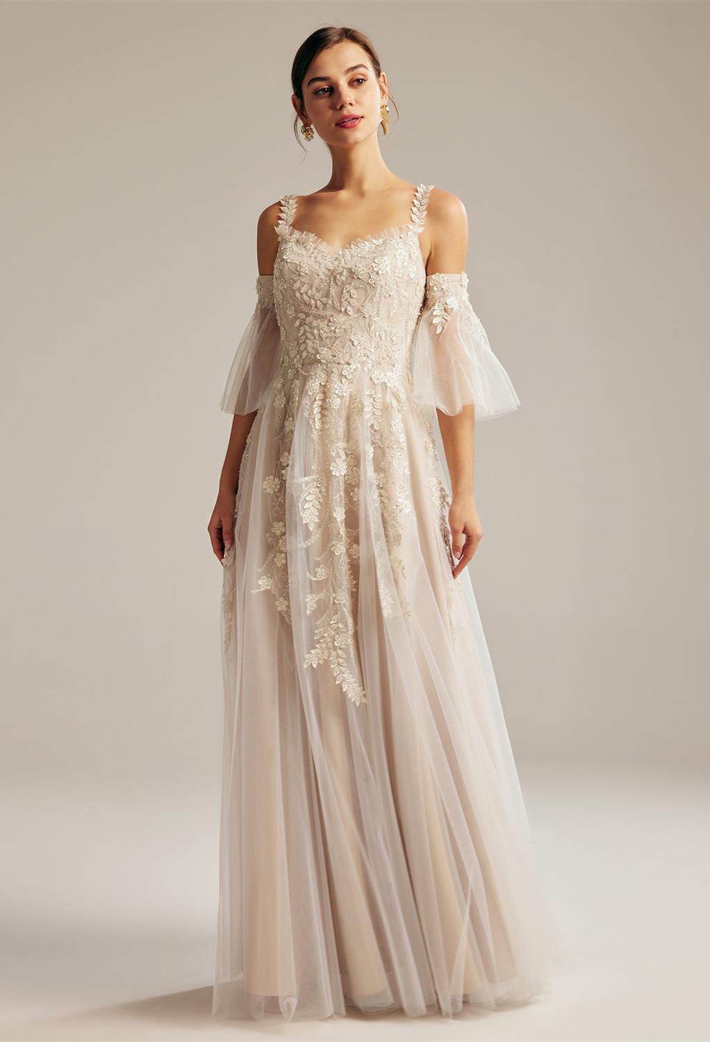 AW Harmonia Wedding Dress with an A-line silhouette and spaghetti strapped trumpet sleeves is a go-to dress for a bride who wants something beyond the conventional. It has a floor-length hemline: hi lo and features a supporting back zipper. The stunning b