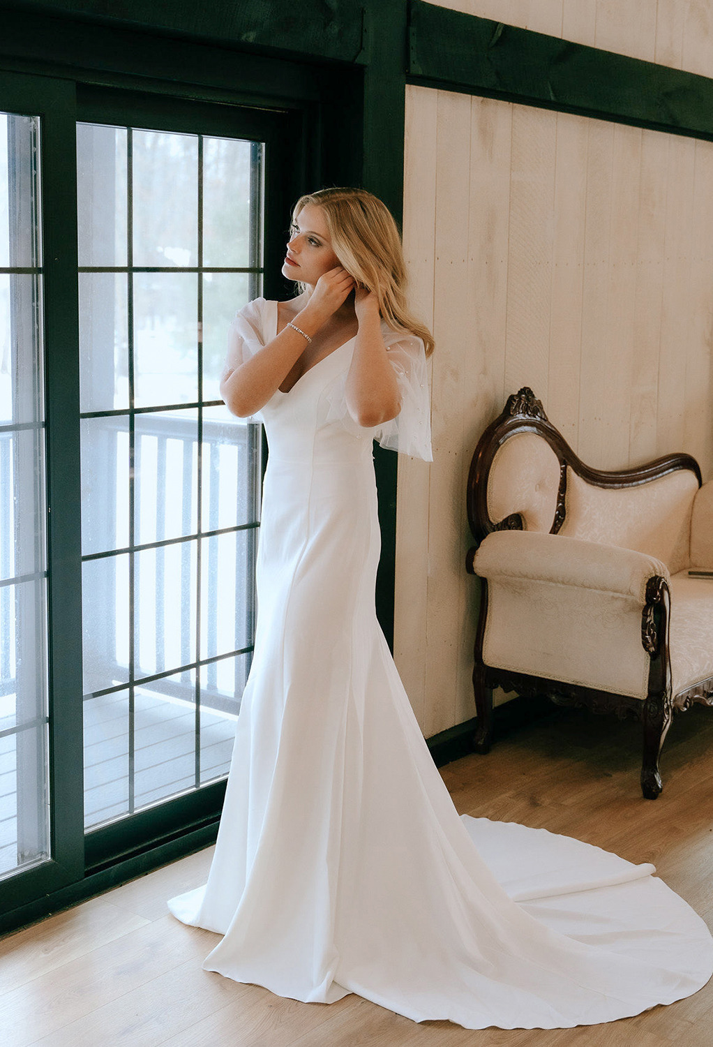 The AW Althea is a satin bridal dress urges brides to u201cShine Bright Like A Diamond.u201d This mermaid-shaped floor-length dress makes a sweetheart feel extra special and the V-neck design helps draw attention to a stunning neckpiece. The butterfly str