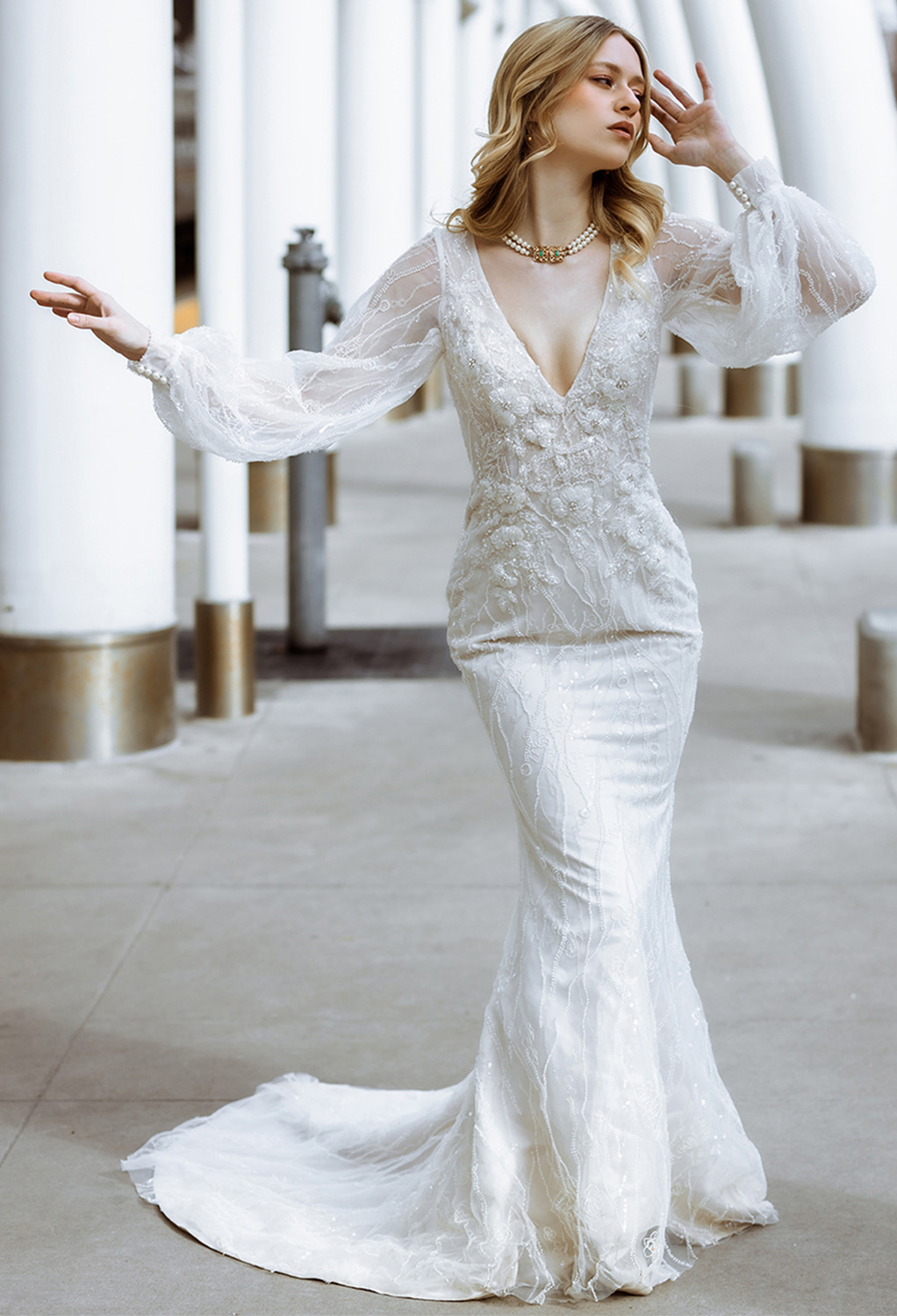 perfect for a bride who admires a simple mix of class and style. The floor-length mermaid silhouette gown is as simple as any wedding gown gets. It offers buttons as its back details