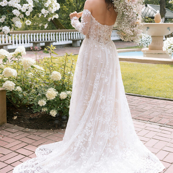 the strapless long-sleeved dress is lined with a built-in bra and is held in place by a bac