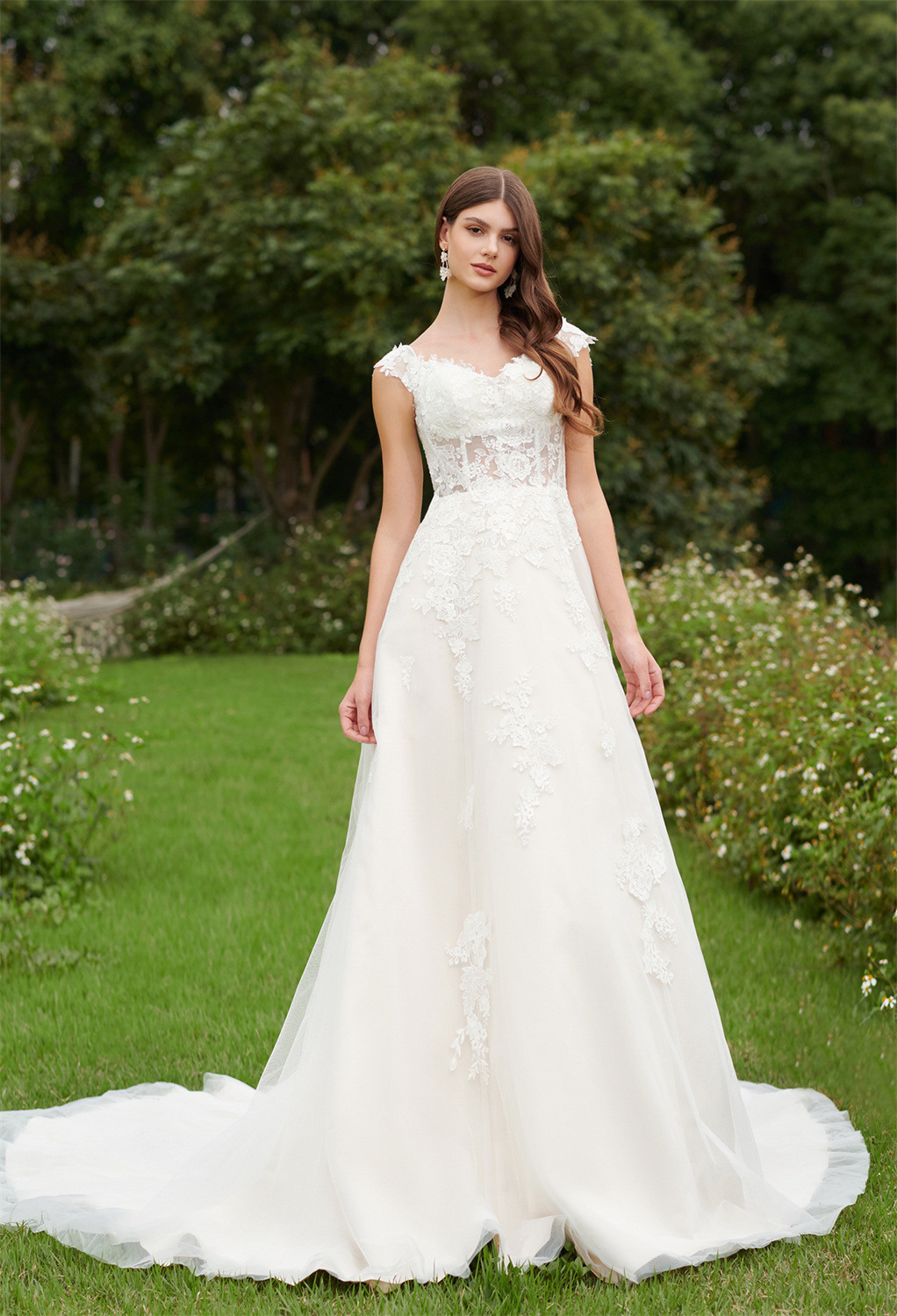 A-line bridal gown features a modest sweetheart neckline on a sleeveless bodice with built-in bra. The floral-like designs accent the jaw-droppingly gorgeous see-through b