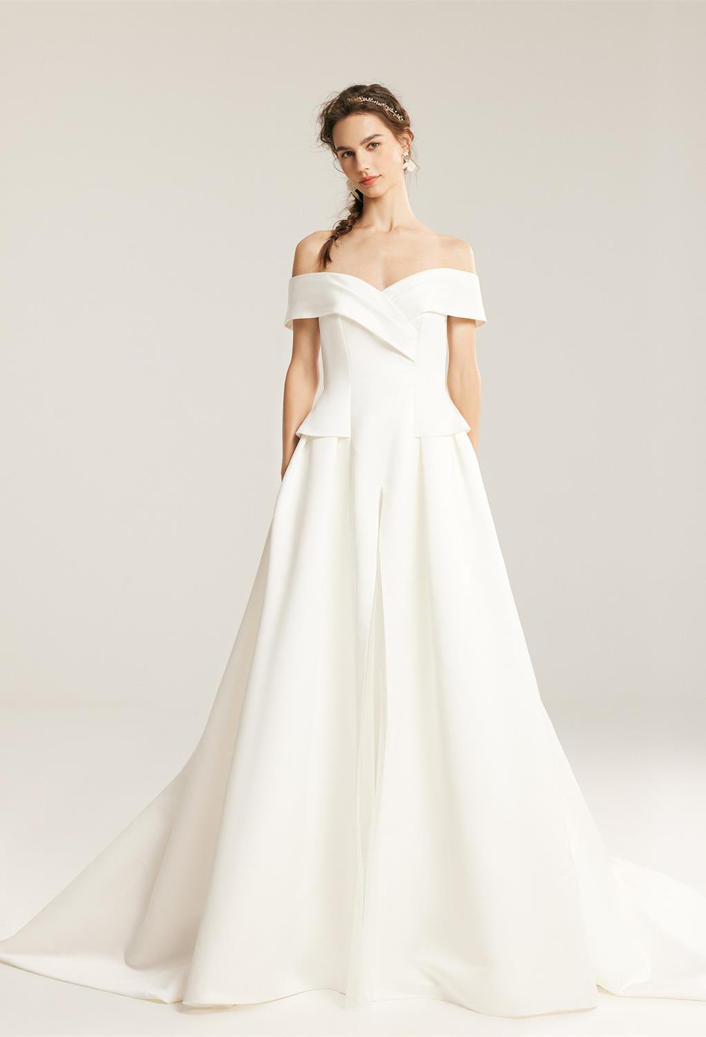 this A-line floor-length wedding dress creates a natural gracefulness with its v-shaped off-shoulder cape neckline. Its bodice hugs the belly int