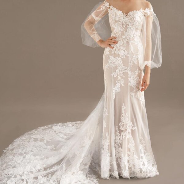The Giana wedding gown features an off-the-shoulder neckline that beautifully frames the face of the bride. The dress offers an almost sheer look that boasts incredibly detailed embroidered embellishments that you will absolutely fall in love with. The tr