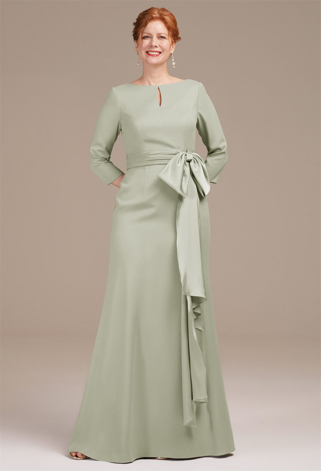 while the cinched waist is highlighted by a charming bow embellishment. Perfect for formal occasions
