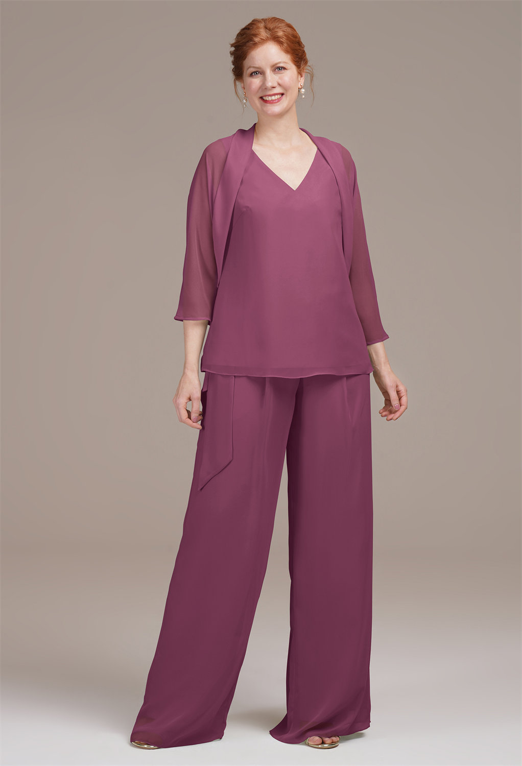creating a sophisticated silhouette. The wide-leg pants have elongating lines that visually extend the leg length