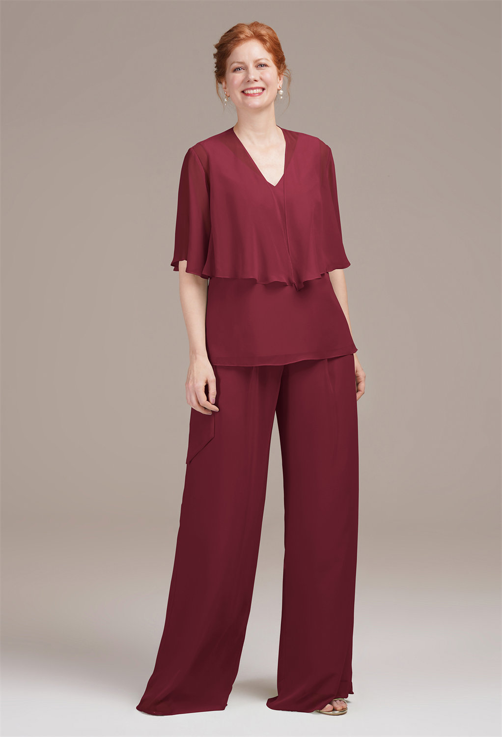 sleeveless V-neck top with a fluttering butterfly sleeve shawl for an air of playful elegance. The wide-leg pants gracefully flow to the floor