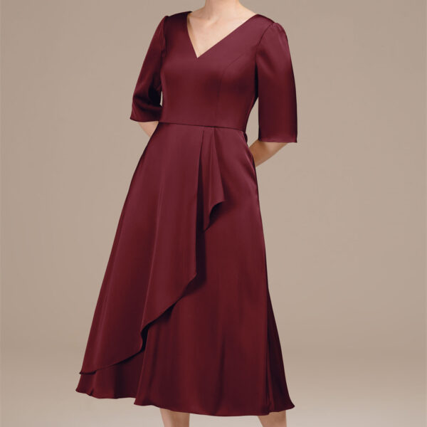 this tea-length A-line dress features a flattering V-neck and sophisticated elbow sleeves. Made from smooth satin charmeuse