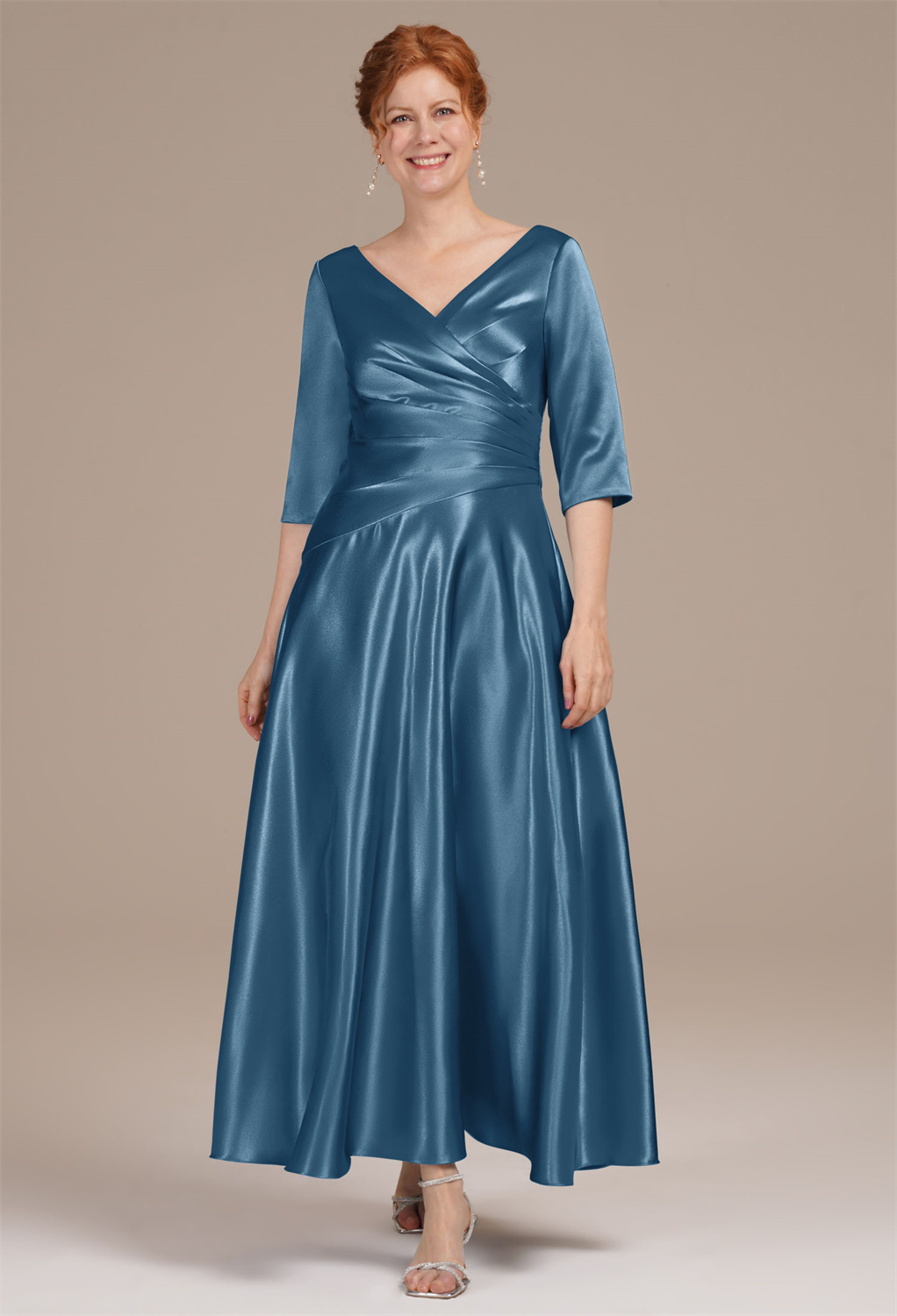 featuring a V-neck artfully crafted with crisscross pleating. Elbow sleeves add a touch of grace