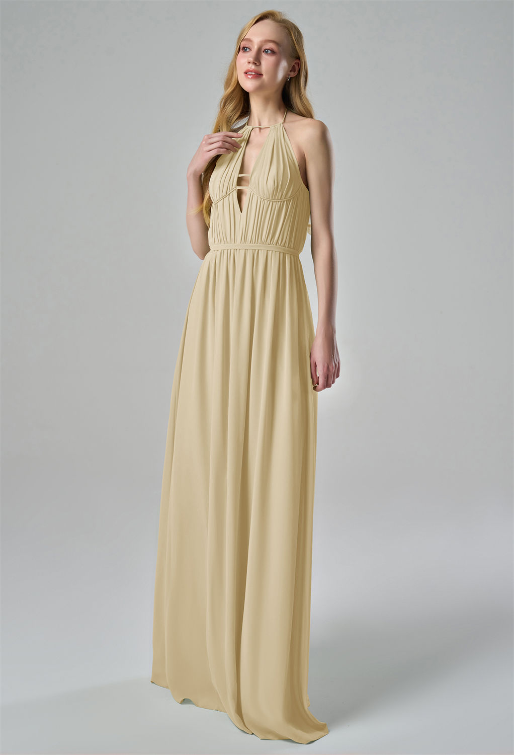 this chiffon bridesmaid dress features a halter neckline with delicate tie-back straps. The pleated bodice adds texture