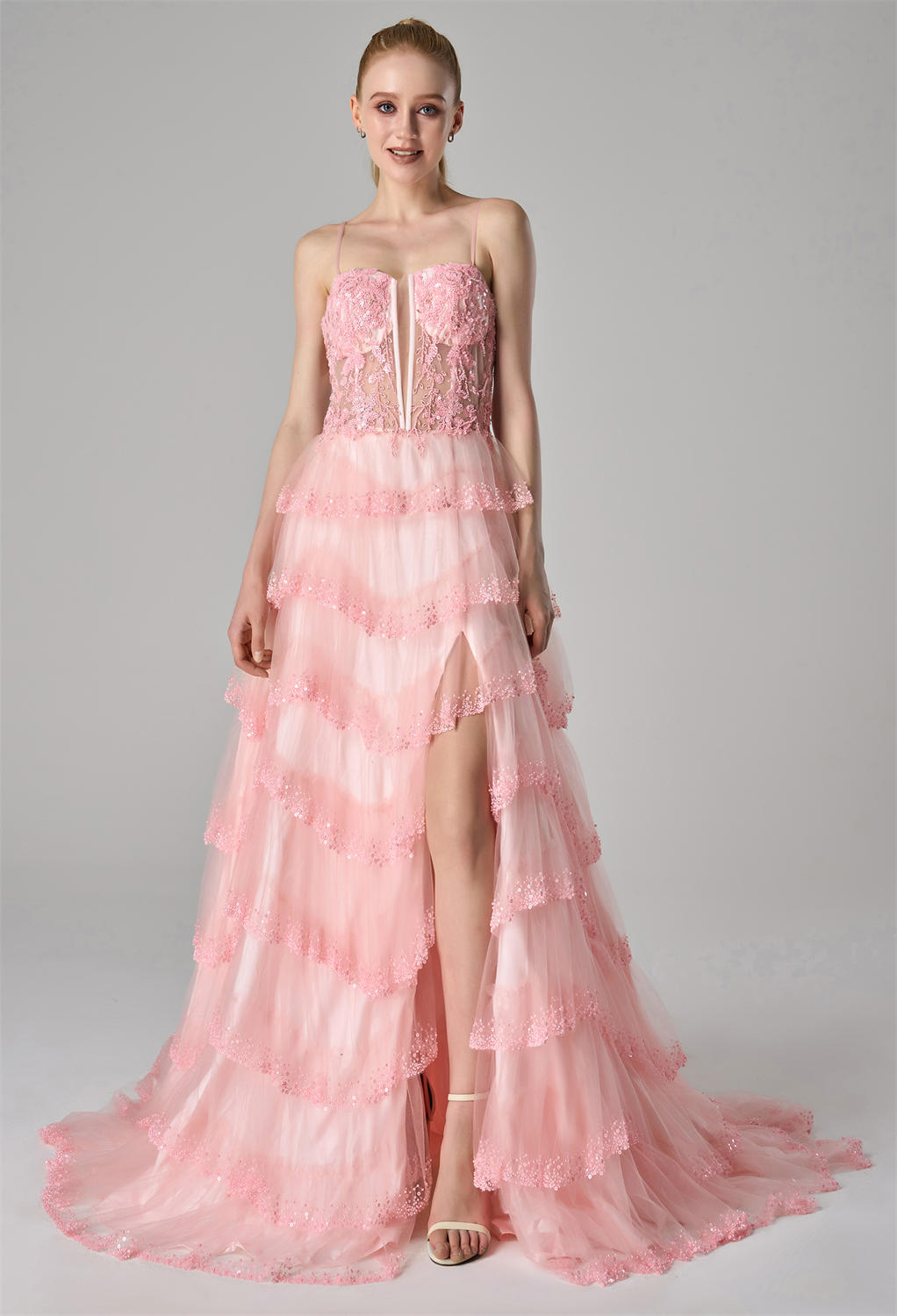 creating a voluminous and ethereal look. A daring front slit adds a touch of allure and