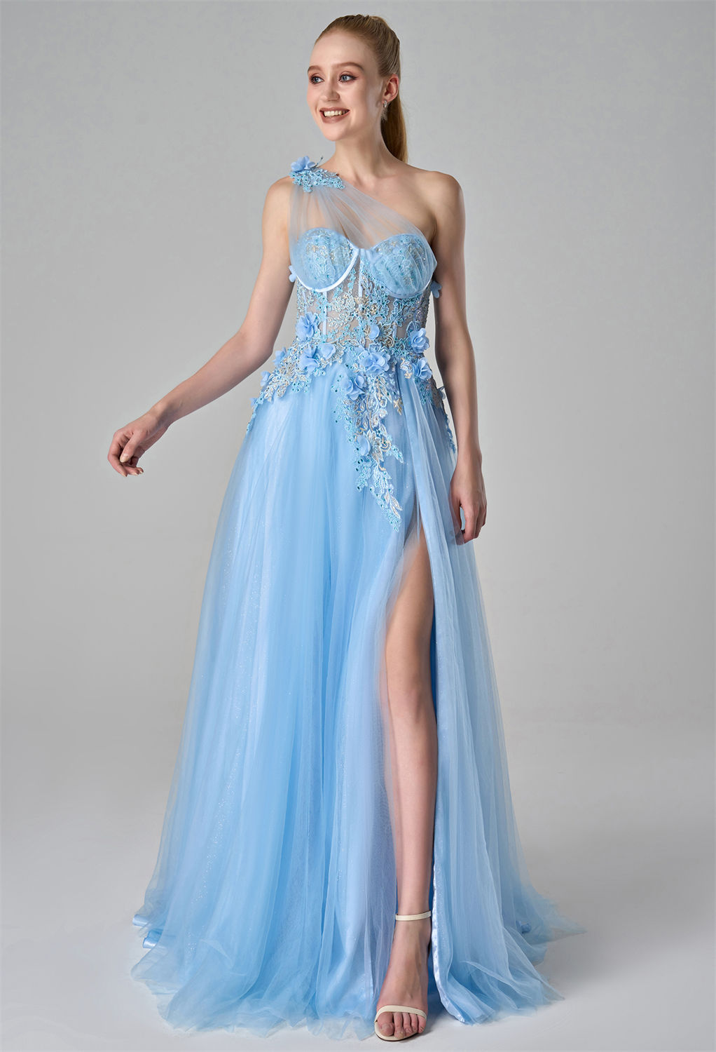 while the flowing tulle skirt includes a high slit for added elegan