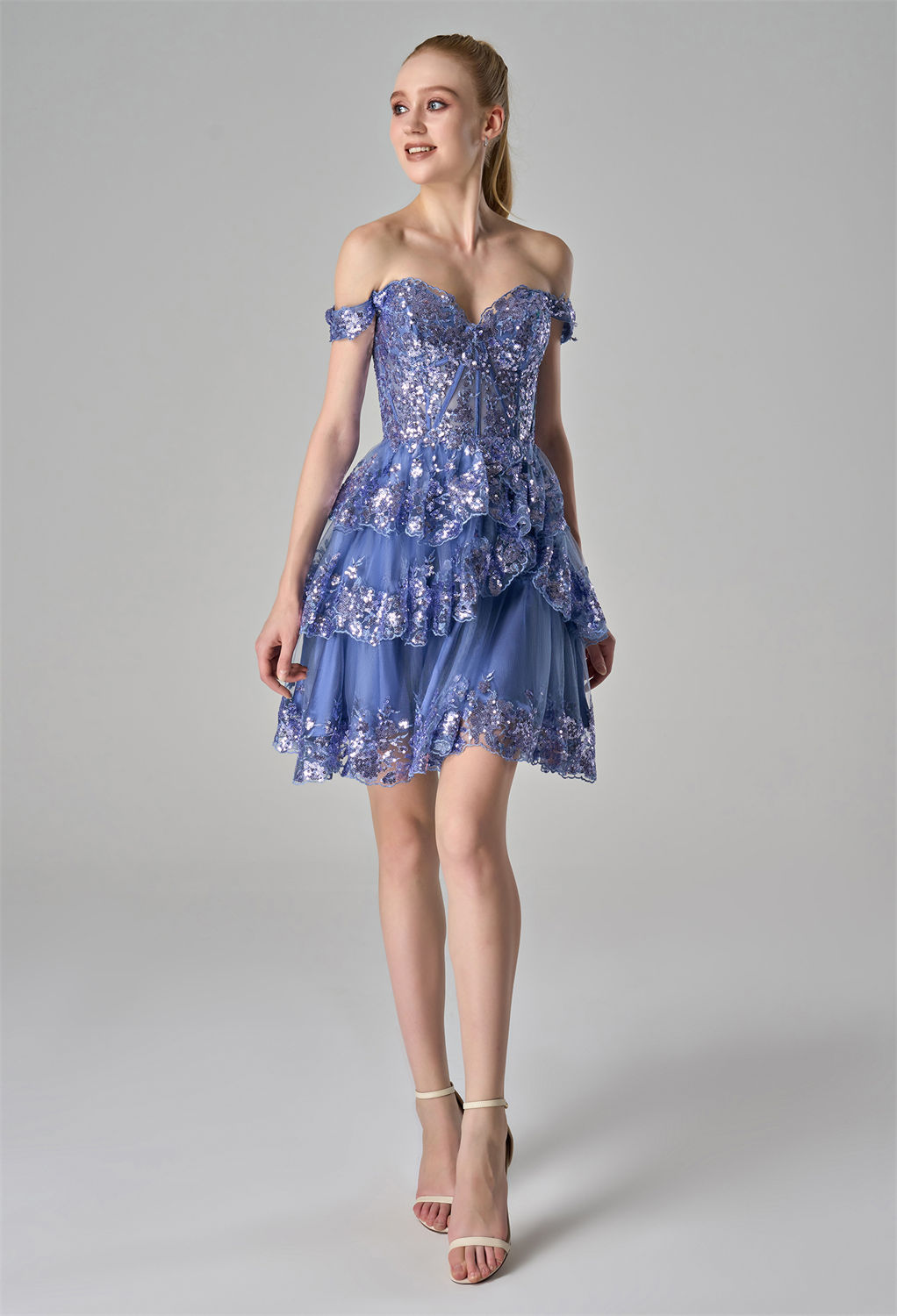 lace-embroidered bodice. The tiered tulle skirt is adorned with intricate lace appliquu00e9s