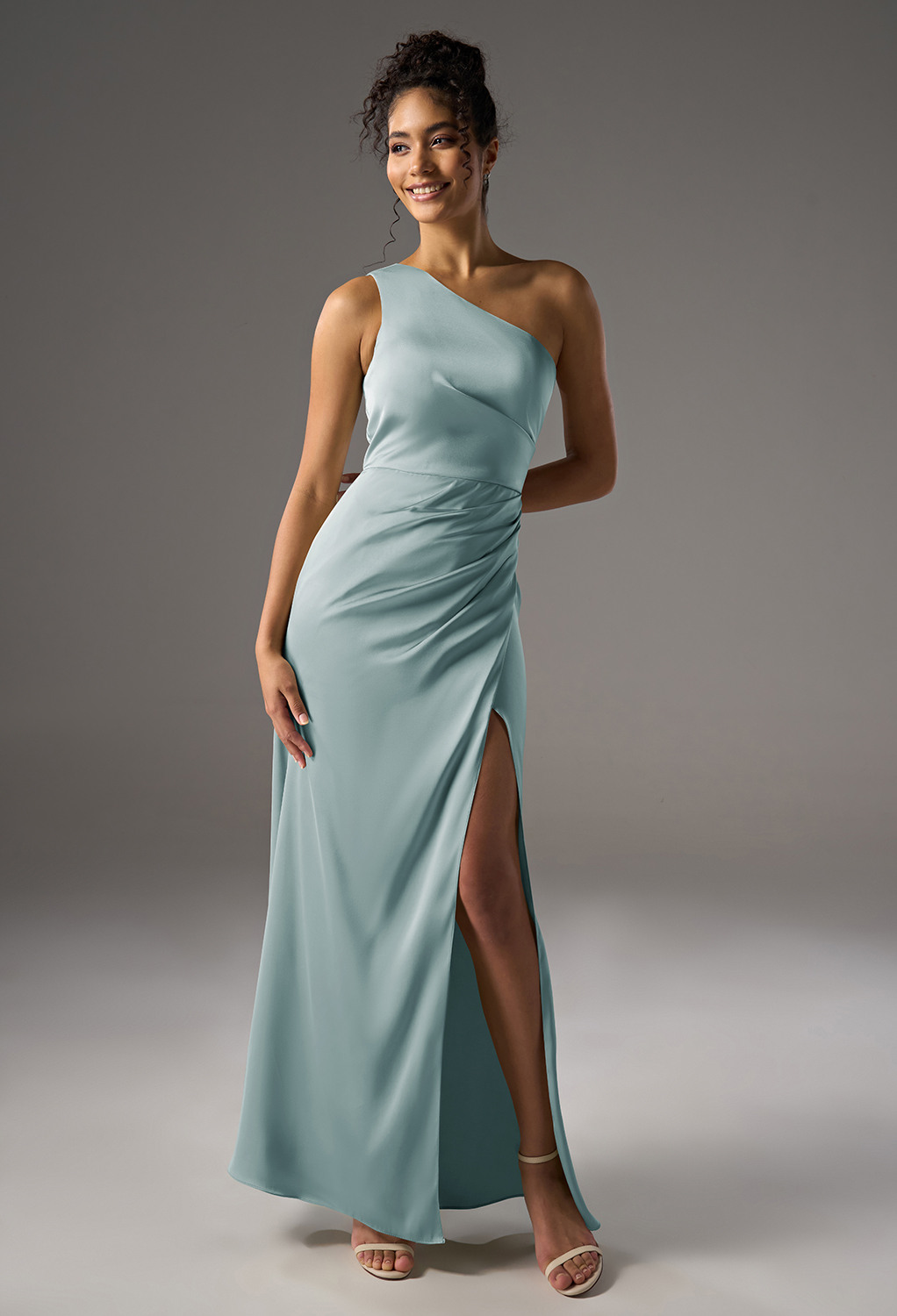 one-shoulder bridesmaid dress made from satin charmeuse or crystal satin. This dress is suitable for formal occasions such as weddings and proms.