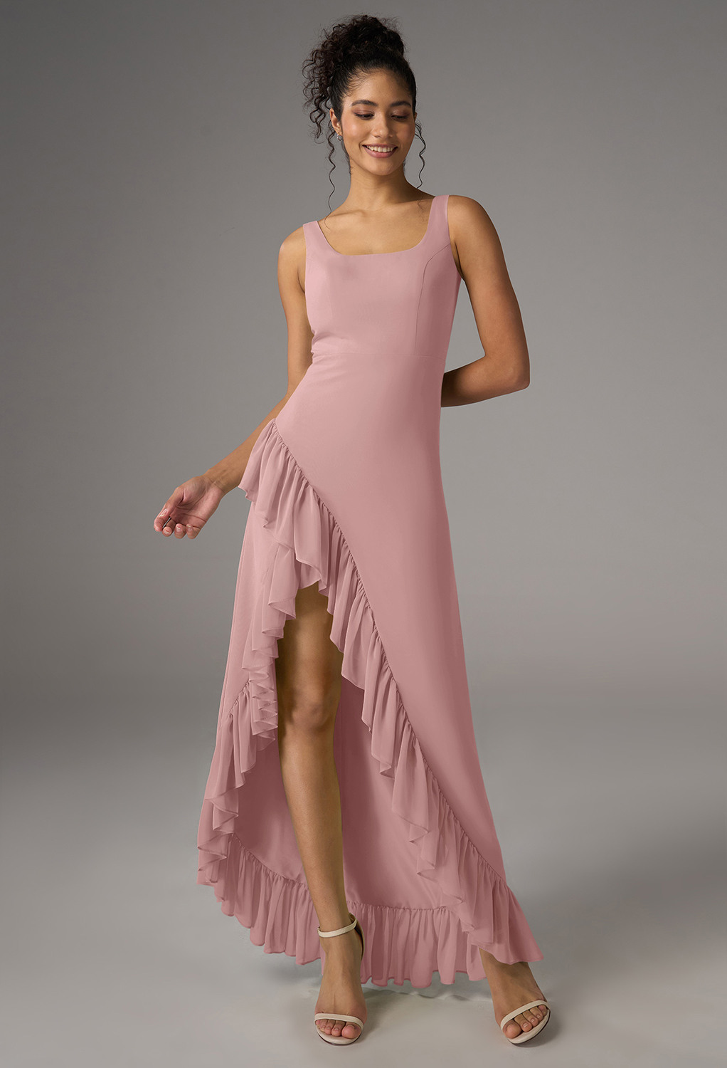 a chiffon A-line design with a hi-lo hem and a scoop neckline. The sleeveless
