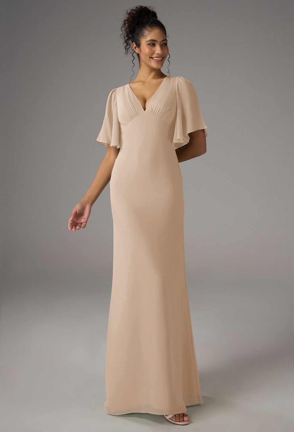 crafted from chiffon in an A-line silhouette with a floor-length hem and V-neckline. Featuring a strapless design with optional short sleeves