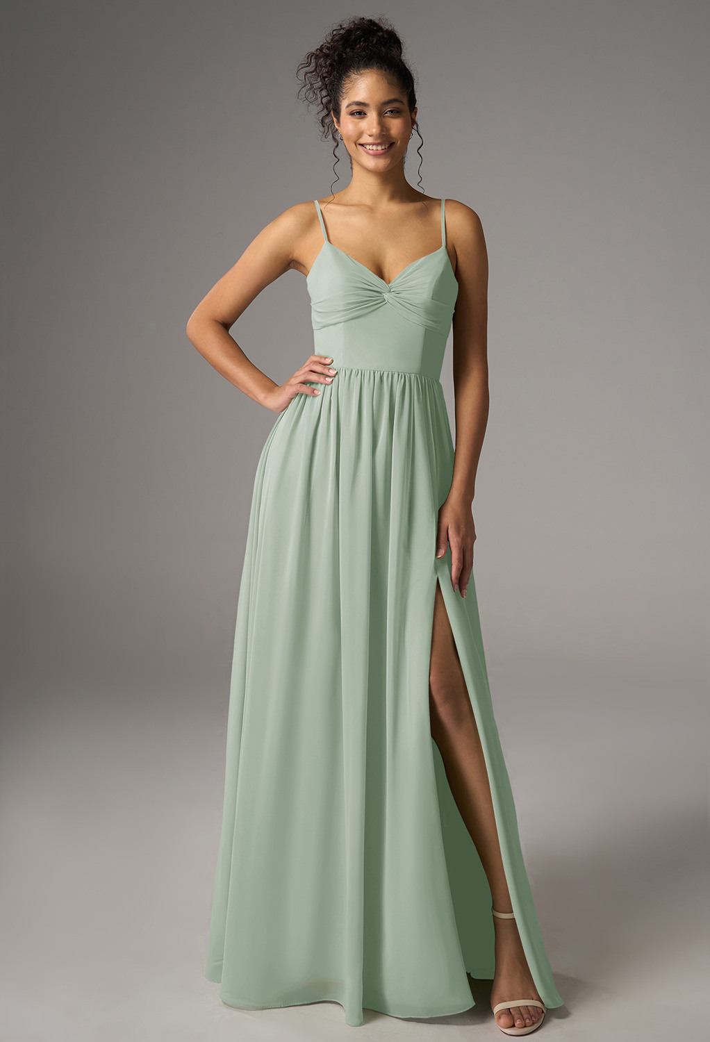 featuring a chiffon A-line silhouette with a floor-length hem and V-neckline. The sleeveless design with spaghetti straps is perfect for garden parties or elegant weddings. Step into effortless charm and sophistication.