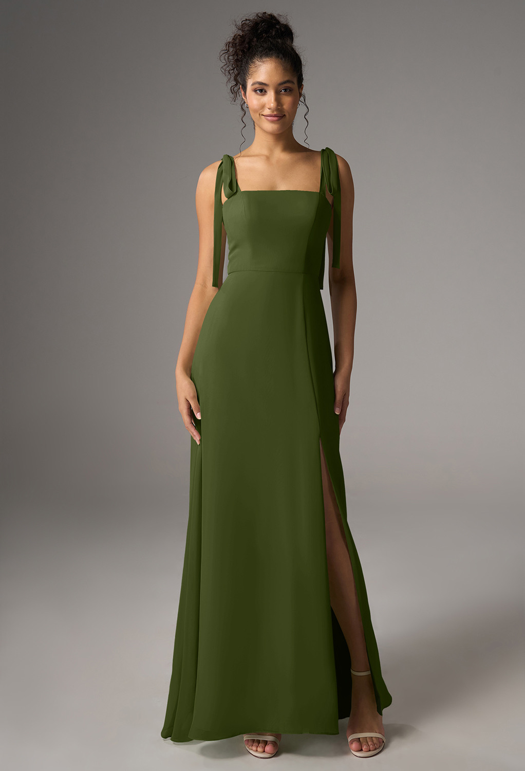 crafted from chiffon in an A-line silhouette with a floor-length hem and square neckline. The sleeveless design with spaghetti straps is ideal for formal occasions or summer weddings. Experience timeless elegance and style