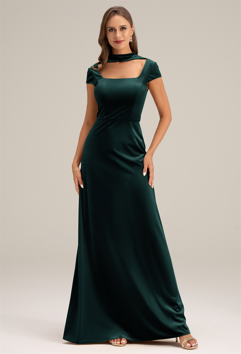 while the floor-length hemline creates a captivating aura.