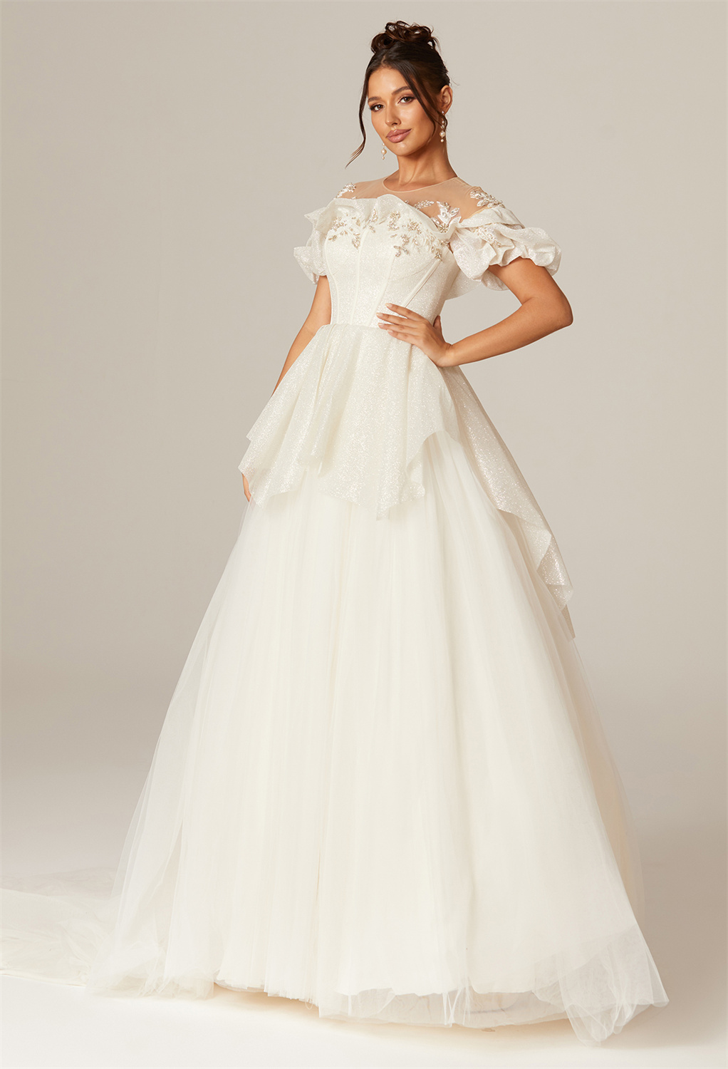 Prepare to walk down the aisle with confidence in our tulle floor-length wedding dress with an A-line cut and U-neckline. The chapel train adds a whimsical and ethereal touch.