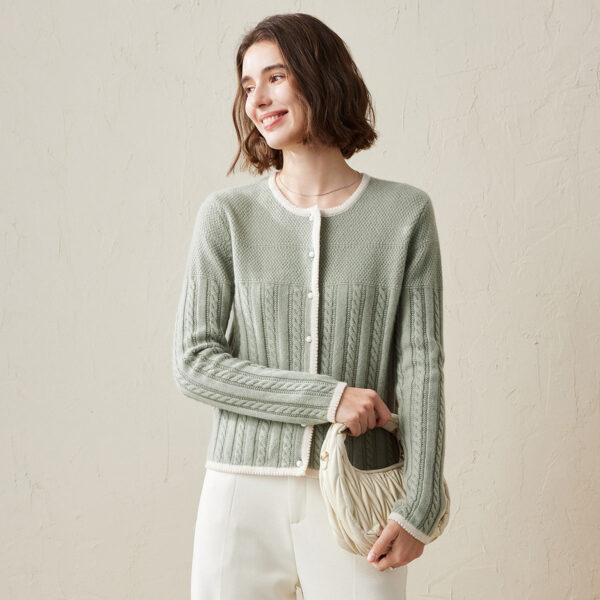The intricate cable knit pattern adds a touch of sophistication