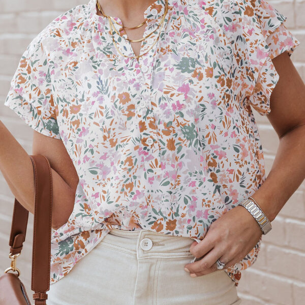 This top is a must-have for adding a touch of flirty floral fun to any outfit. Made from soft