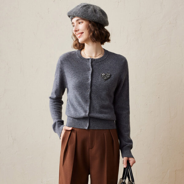 Add a touch of elegance to your wardrobe with our Embellished Cardigan featuring a stylish heart patch. Crafted from premium knit cashmere