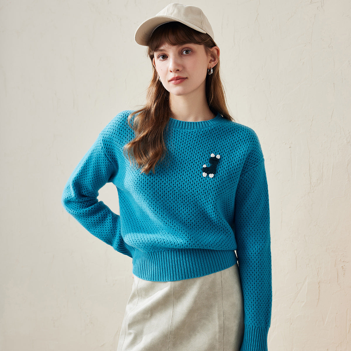 Add a playful touch to your wardrobe with our Embroidered Patch Knit Sweater. This charming piece combines cozy comfort with a fun