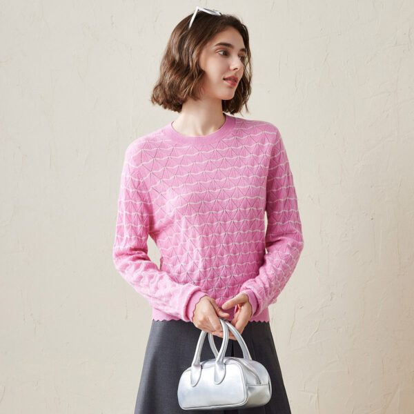 This charming women's knit sweater is designed with a delicate scallop trim and an all-over geometric pattern that adds texture and style to your everyday look. The soft