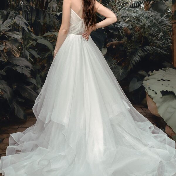 barely there straps and lots of lovely layers that add incredible romantic dimension to your look. The wedding dress is offered in a crisp bridal white or an elegant ivory that lends an old world charm