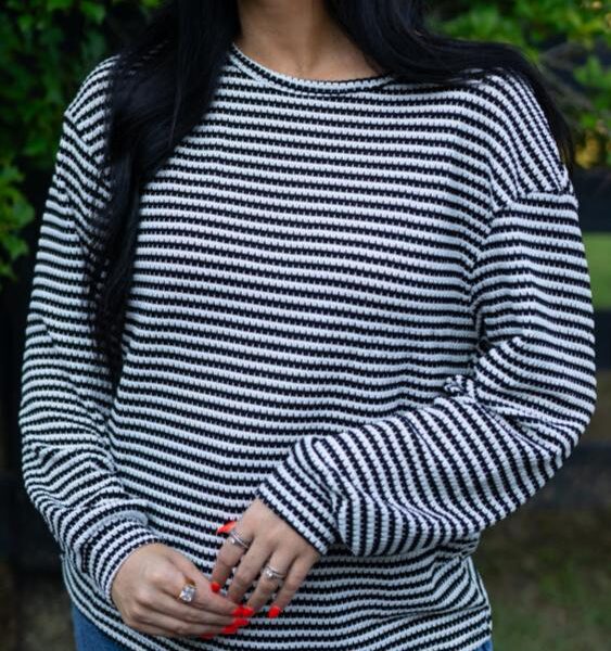 Get ready to rock a top that's effortlessly chic - this women's top features a classic striped pattern that's sure to make a statement. With a relaxed drop shoulder design and a comfortable round neck