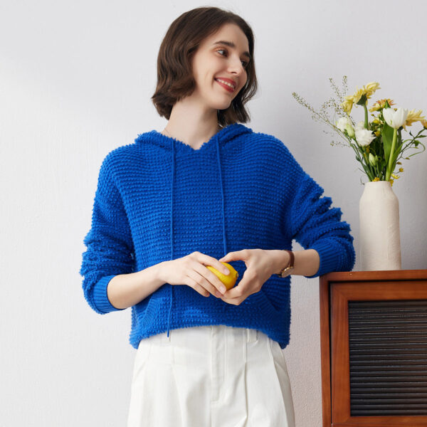 Elevate your casual style with this cozy textured knit hoodie. The unique popcorn style knit adds dimension and interest to this vibrant blue hoodie