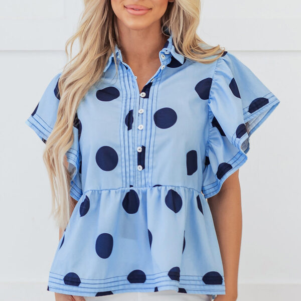 This charming blouse has a playful polka dot pattern