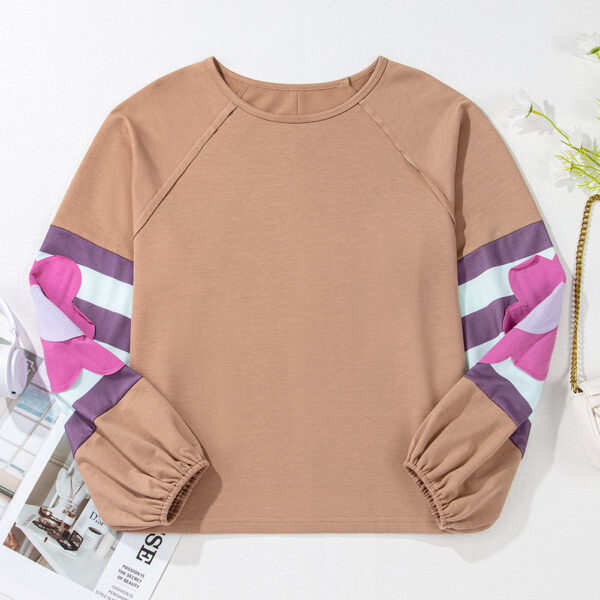 Be effortlessly stylish in this oversized pullover featuring a vintage-inspired mineral wash and playful bubble sleeves with elastic cuffs. With contrasting color stripes on the sleeves