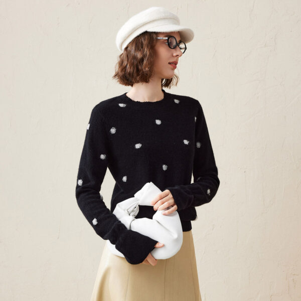 Add a touch of playfulness to your wardrobe with our Women's Cozy Polka Dot Sweater. This stylish knit sweater features a whimsical polka dot pattern against a solid background