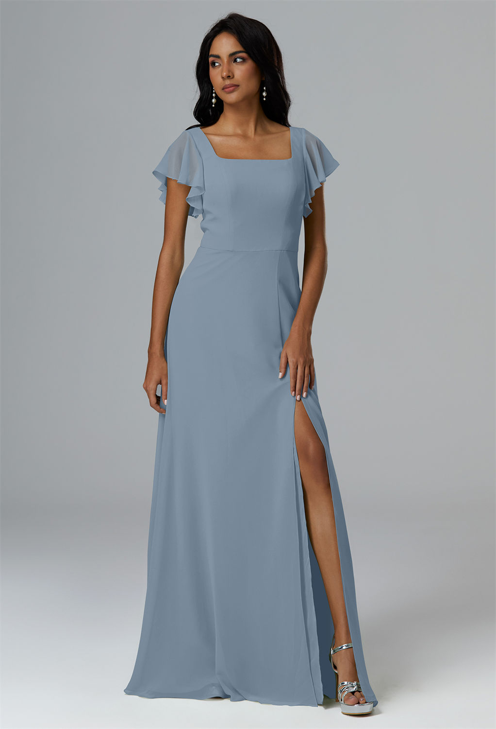graced with a square neckline and a floor-grazing hem