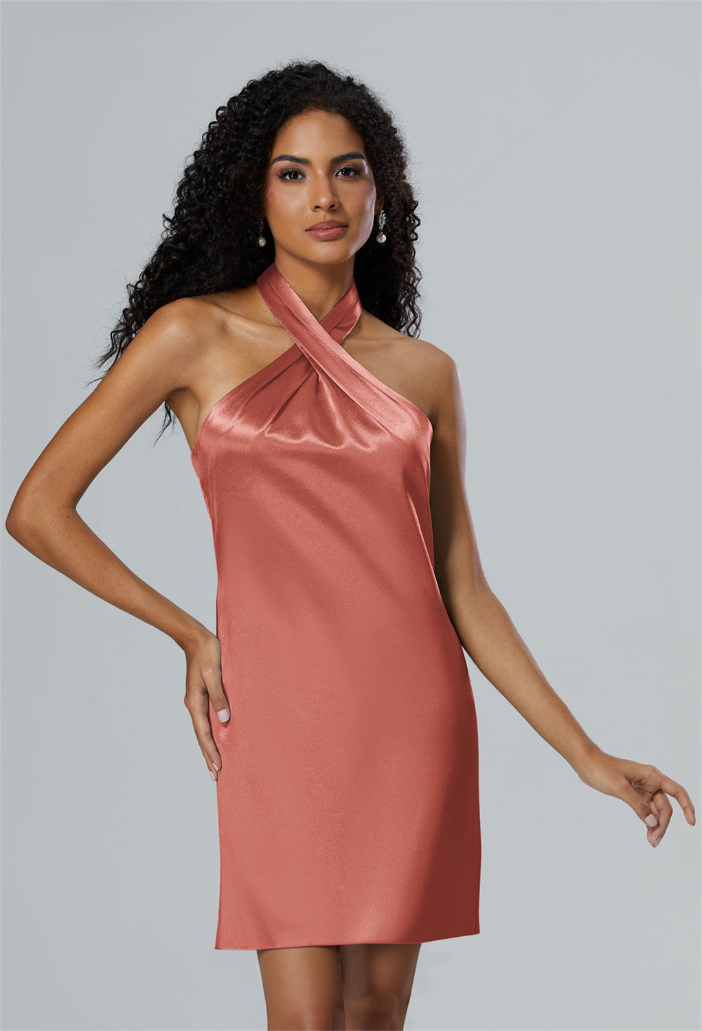 where the v-neck pairs daringly with a sleeveless and strapless design. The crystal satin fabric shimmers with every step