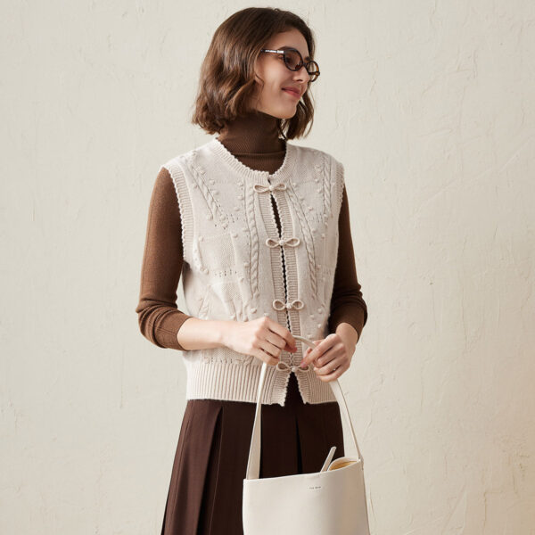 Elevate your wardrobe with this charming vintage-inspired cable knit sleeveless vest. Crafted from soft