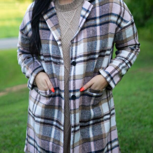 Show off your fashion sense with this vibrant plaid coat. The lapel design makes it perfect for formal events. The tunic length adds warmth