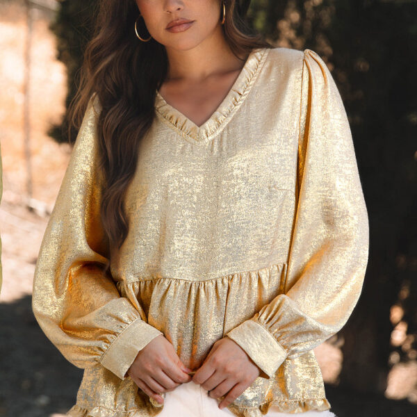 Shine bright in this metallic fabric babydoll blouse! Featuring a flirty frilled V-neckline