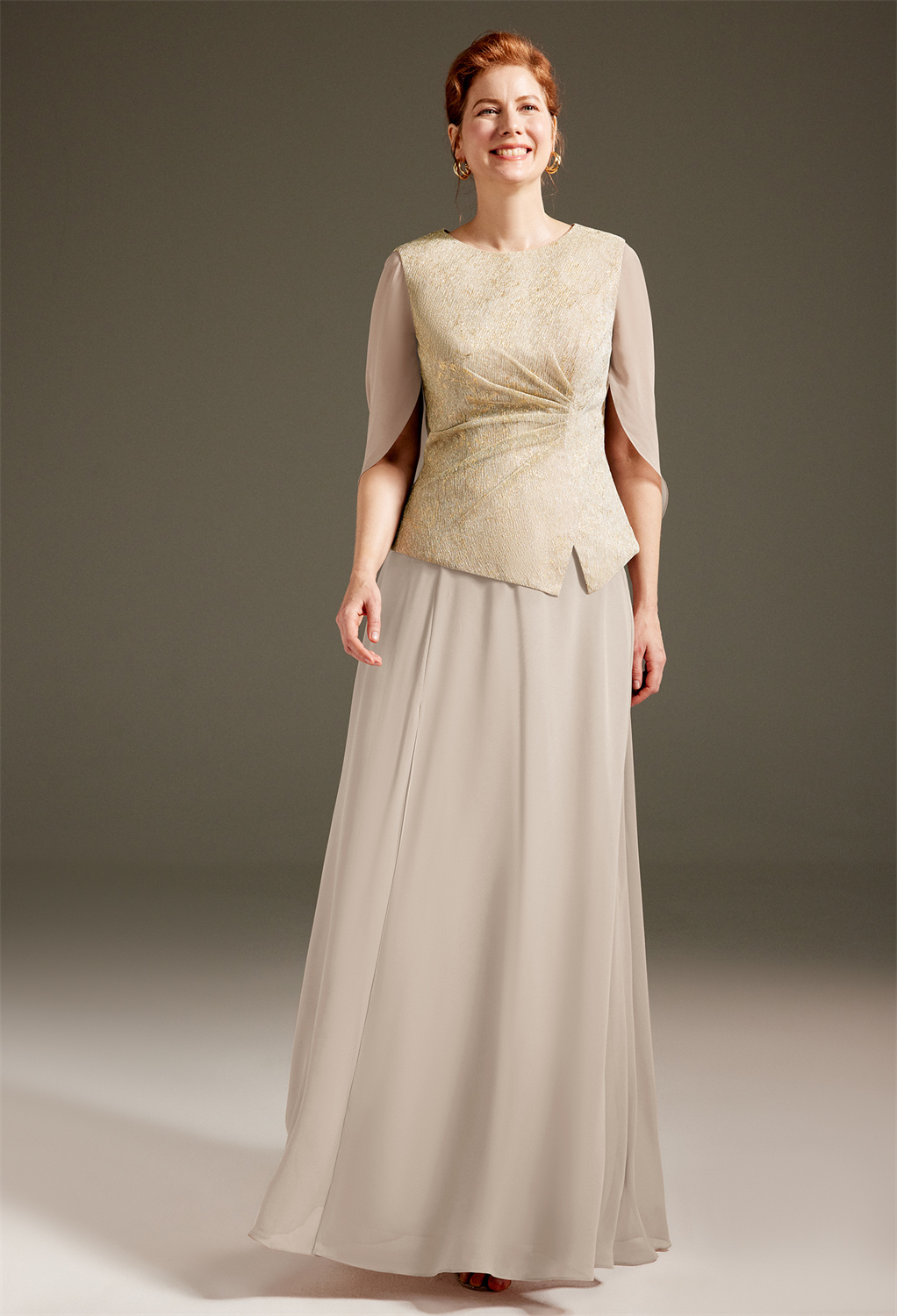 floor-length dress is designed from exquisite shimmer pleated mesh. It captivates a beholder with its alluring jewel neckline bodice with side drapes