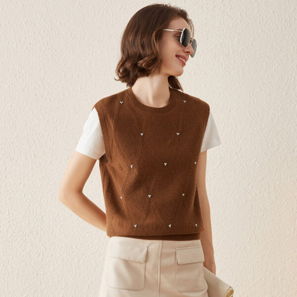 Elevate your wardrobe with our 100% Cashmere Elegant Pearl-Embellished Knit Vest. This stylish piece seamlessly combines classic charm with contemporary elegance