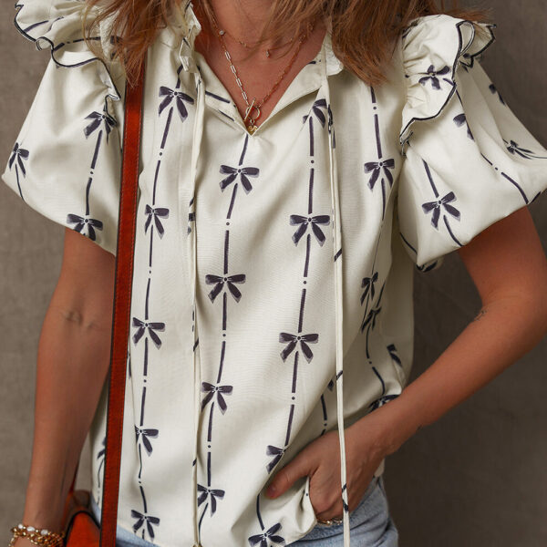 This blouse boasts an adorable bow pattern all over