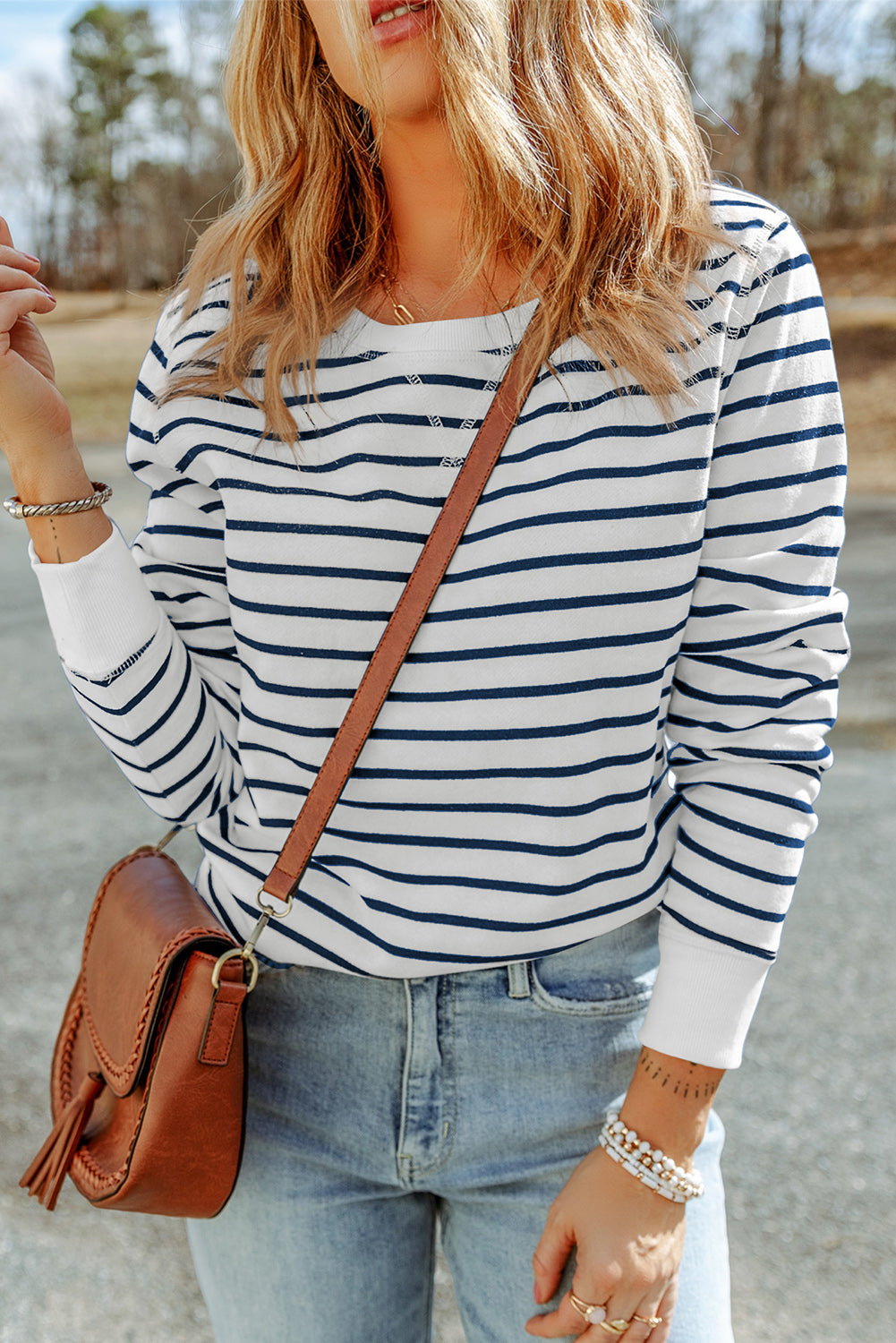 Elevate your style with this trendy long sleeve top featuring a timeless striped print and playful ribbed accents at the cuffs